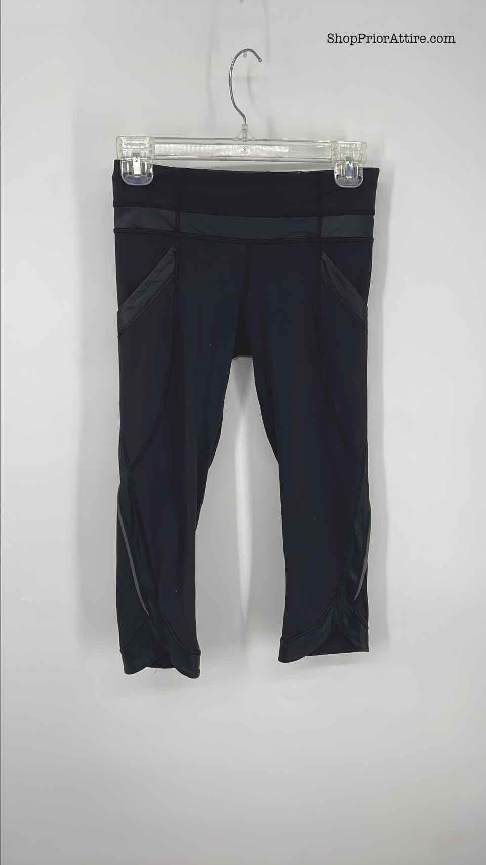 black lululemon leggings with pockets and mesh on
